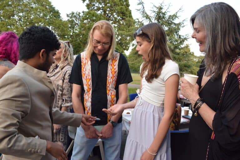 Interactive party magic show creating laughter and reactions at a cambridge celebration