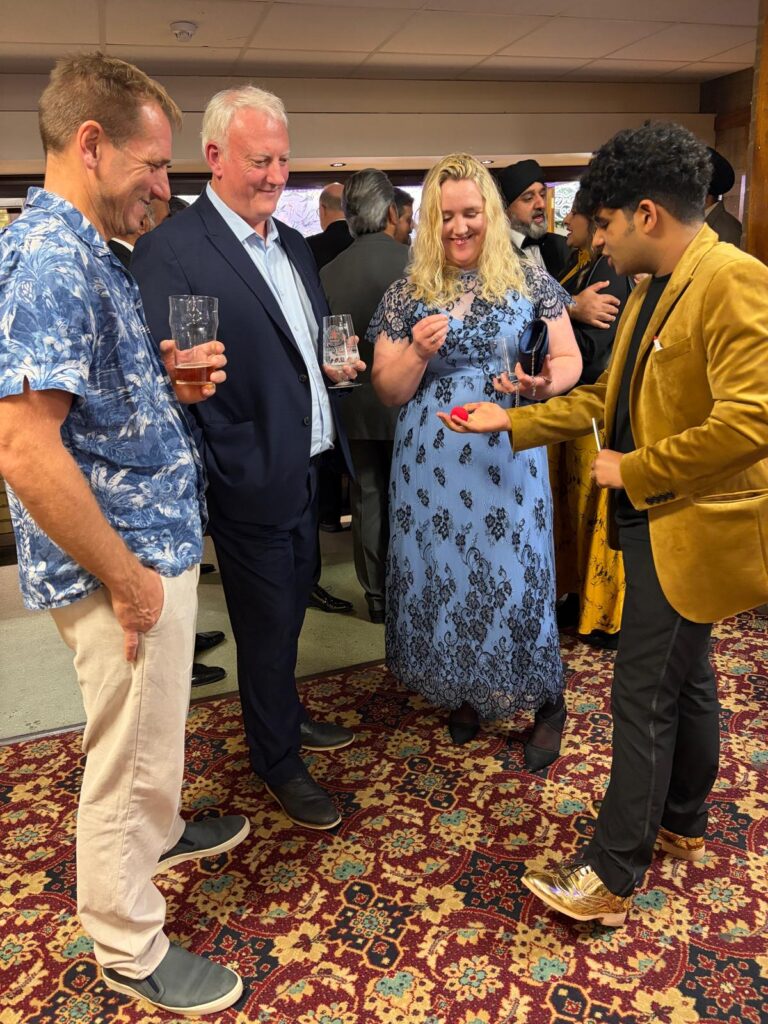 Magician in Bedford performing close-up magic for guests at bedford Diwali Ball